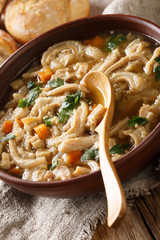 Polish stew flaki with vegetables close-up in a bowl. vertical