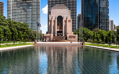 Exterior view of ANZAC war memorial in Hyde park with water pond in the front in Sydney Australia