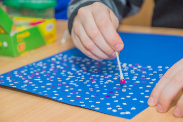 education, school, art and painting concept - showing painted hands