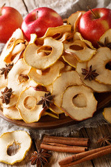 Healthy eating apple chips with cinnamon and star anise closeup on a plate. vertical