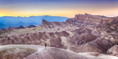 Man watching sunset at Zabriskie Point, Death Valley National Park, California, USA