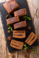 Traditional Polish dessert Piernik with plum jam closeup. Vertical top view