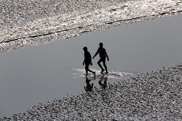 Fototapeta na wymiar Mud beds on the river Malta during low tide the water in the Canning Town, India 