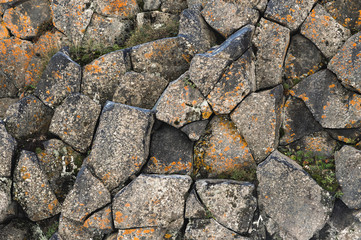 Textured basalt background hexagonal stone pillars in a section. natural volcanic formations