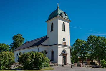 Fototapeta na wymiar White church building made of stone in summer sunshine