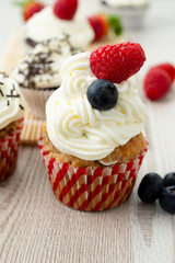Decorated cupcakes on a wooden table.