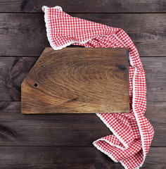 Empty very old wooden kitchen cutting board and a red towel