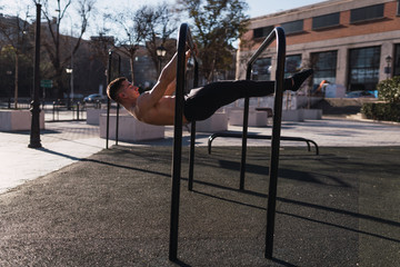 Young guy training on parallel bars