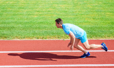 Runner captured in motion just after start of race. Boost speed concept. Man athlete runner push...