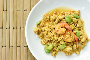 spicy stir fried twisted cluster bean with shrimp and chop chicken on dish