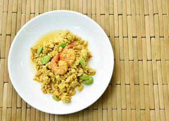 spicy stir fried twisted cluster bean with shrimp and chop chicken on dish