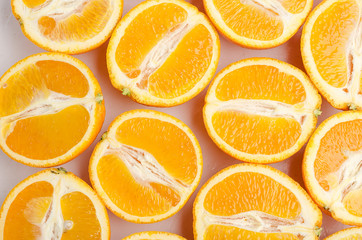 Halves of oranges on a white.