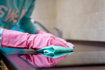Image of hands in pink gloves washing hob