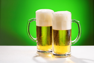 Two mugs of beer. Concept for St. Patrick's day.