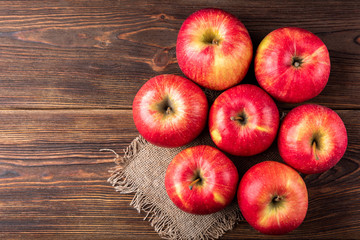 Red apples on dark wooden background.