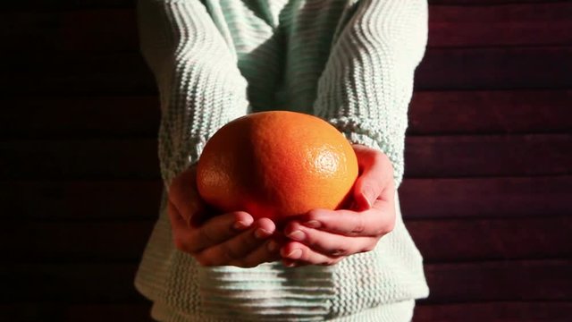 Woman hands with orange grapefruit, healthy food