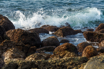 Fototapeta na wymiar waves striking at the rocks of Каtа beach on the Phuket island of Thailand