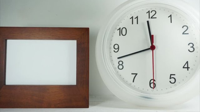   Closeup white clock hanging on wall ticking and Photo frame. Full HD 1920x1080p.