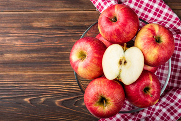 Red apples on dark wooden background.