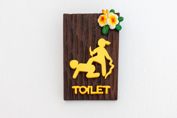 a signboard on a toilet door in a thai hotel