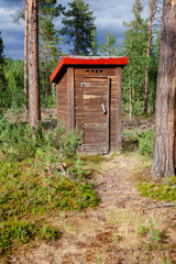 Fototapeta na wymiar Outhouse in a forest in Norway