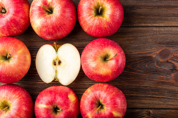 Red apples on dark wooden background.