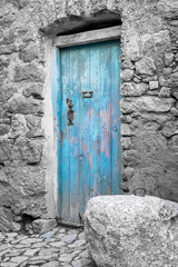 Blue door in a traditional village house of Corsica, France