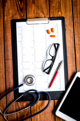 doctor workplace at wooden table in lab top view