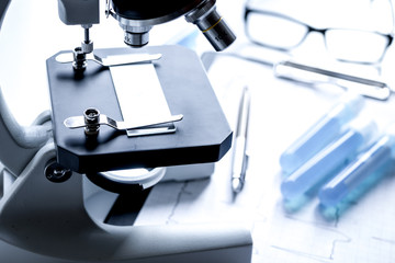 doctors desk with microscope and test tubes