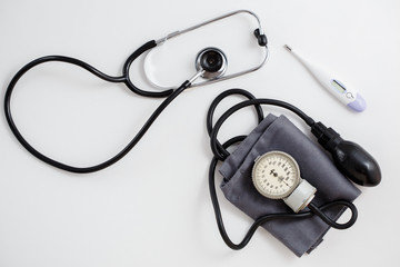 Concept for medicine. Vintage tonometer and stethoscope on white isolated background. View from...