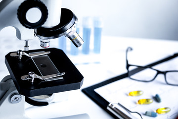 doctors desk with microscope and test tubes