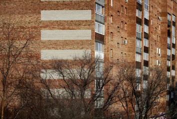 Apartment building. Architectural background. Ust-Kamenogorsk (Kazakhstan). Brown Brick. Residential area