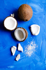 coconut slices and milk on blue background