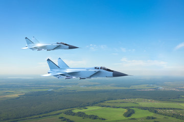 Couple military jet fighter aircraft, flying above ground
