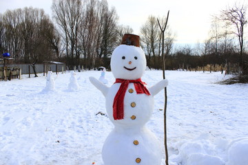 Snowman joyful. Christmas snowman made in garden