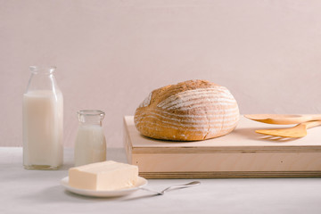 Bread bake and butter on wooden cutting board. Simple breakfast