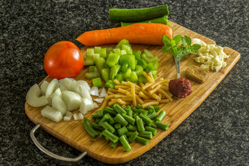 rae cut vegtables on a wooden board 