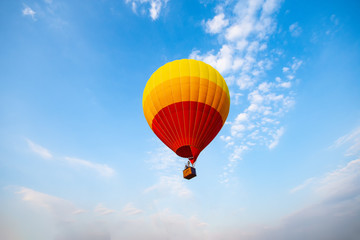 hot air balloon is flying at morning sunrise