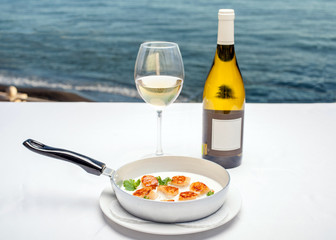 Dish of scallops on the background of the sea