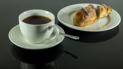 black tea and a cinnimon bun 