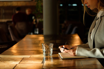 Business woman holding a phone in her hands.