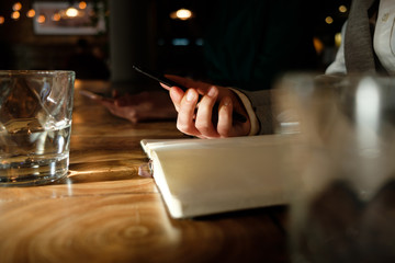 Business woman holding a phone in her hands.