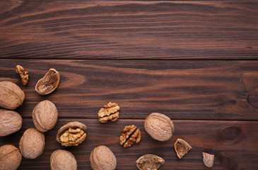 Walnuts kernels on brown wooden background. Walnut healthy food