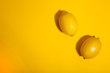 Fresh lemons on yellow background. Tropical fruit.