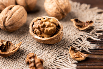 Walnut on dark wooden background.