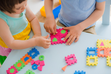 little girl playing with puzzle, early education