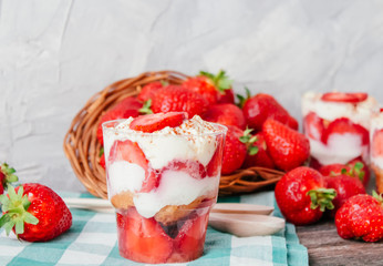 Strawberries with cream or tiramisu in small glasses 