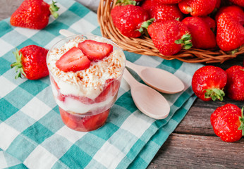 Strawberries with cream or tiramisu in small glasses 