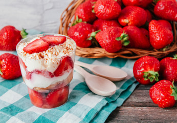 Strawberries with cream or tiramisu in small glasses 