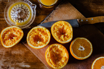 Oranges and squeezer on wooden table